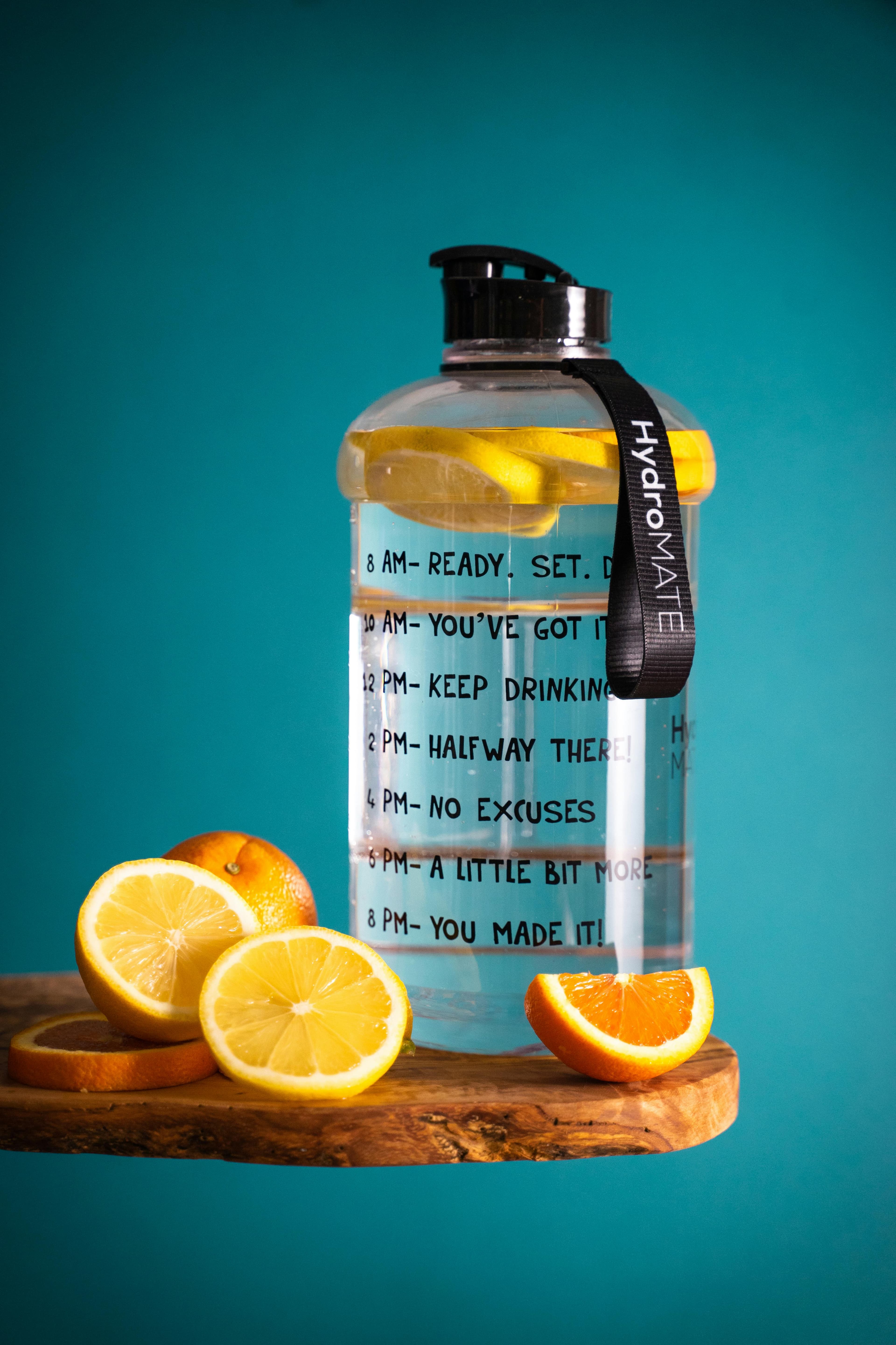 A reusable water bottle with markings indicating the time to drink