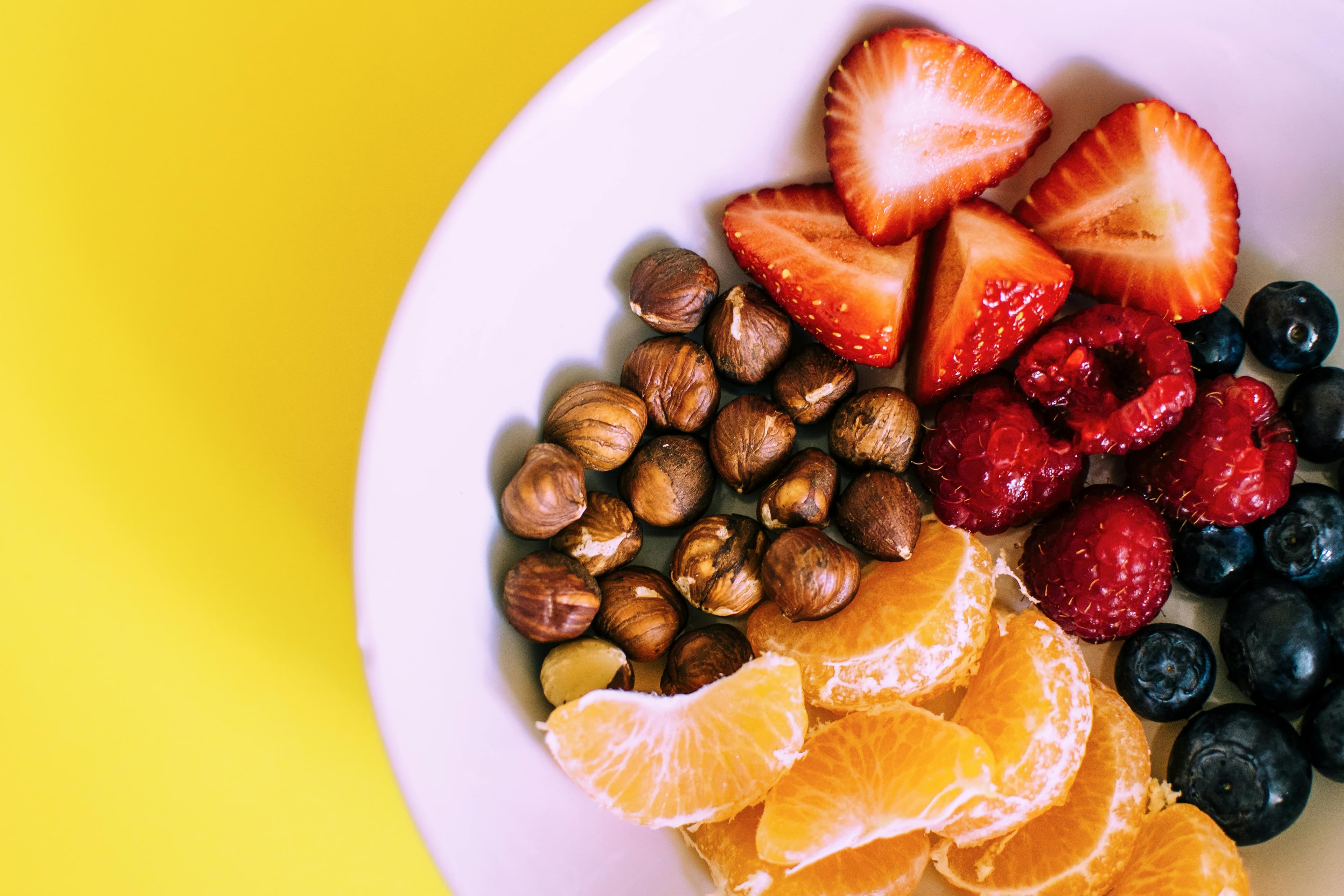 A plate of an assortment of berries and nuts