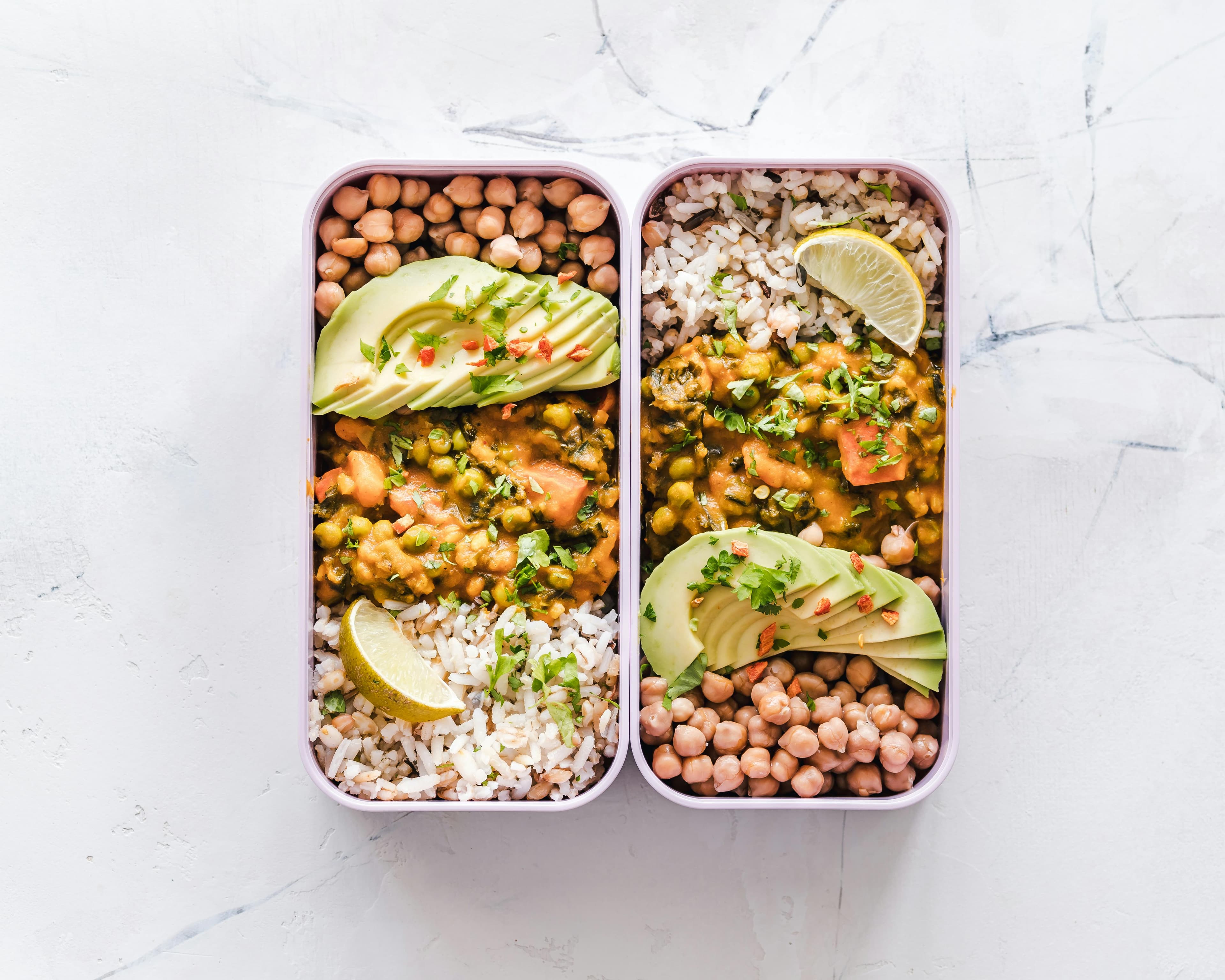 Two meal prep containers with two pre-prepared vegetarian meals